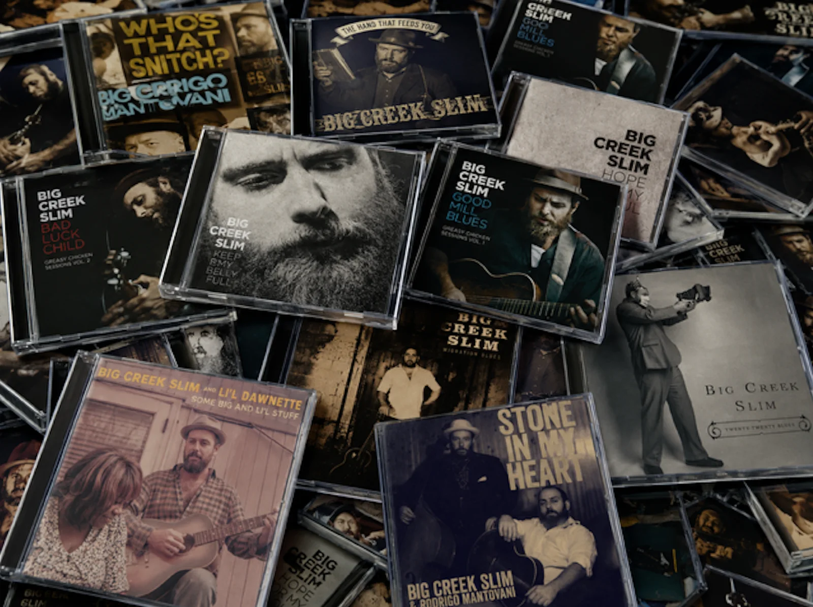 Big Creek Slim CD collection arranged across a table